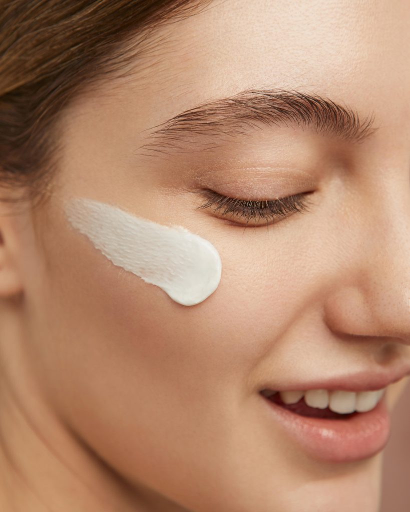 smiley woman posing with face cream